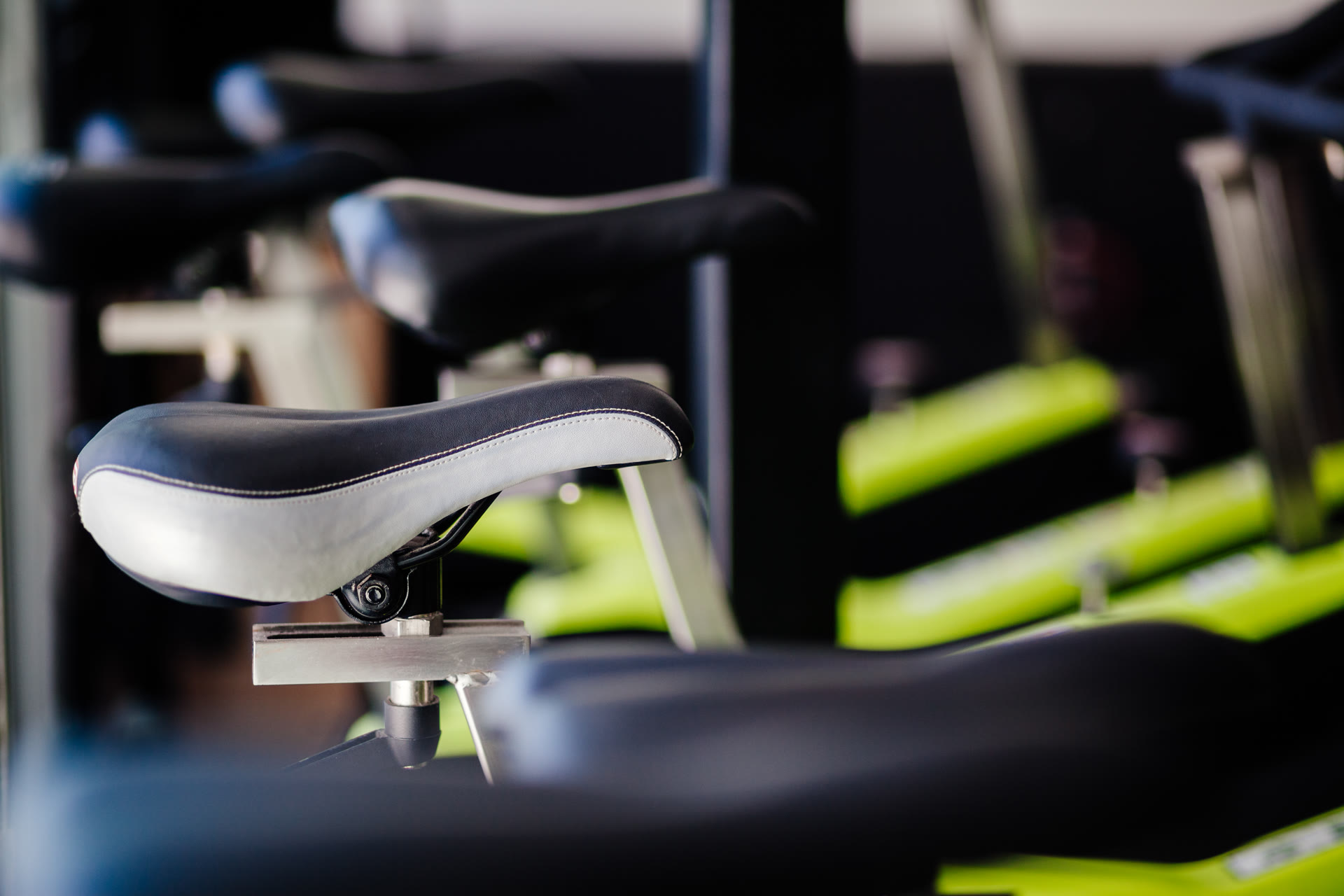 A close up of a saddle in a row of bikes at Sculpt x Cycle Riverside